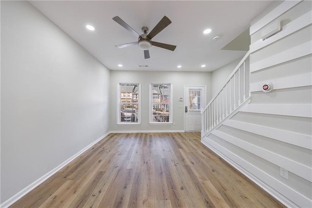 unfurnished room featuring a healthy amount of sunlight, stairway, and recessed lighting