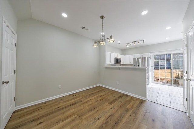 interior space featuring light wood-style floors, baseboards, visible vents, and recessed lighting