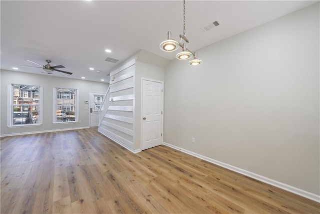 interior space with light wood-style flooring, visible vents, baseboards, and recessed lighting