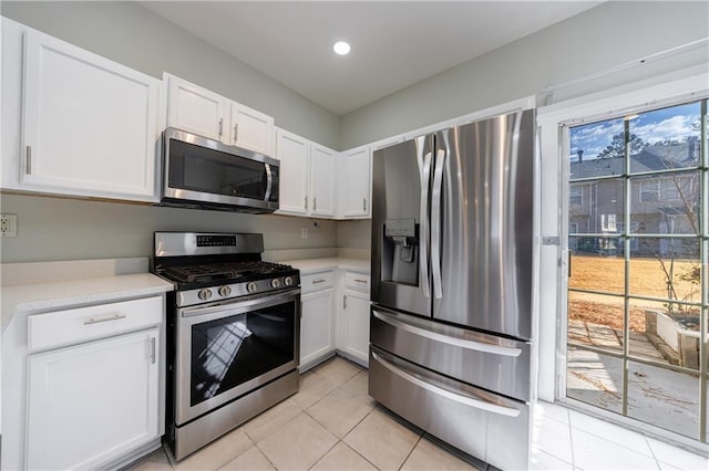 kitchen featuring light tile patterned floors, recessed lighting, light countertops, appliances with stainless steel finishes, and white cabinets