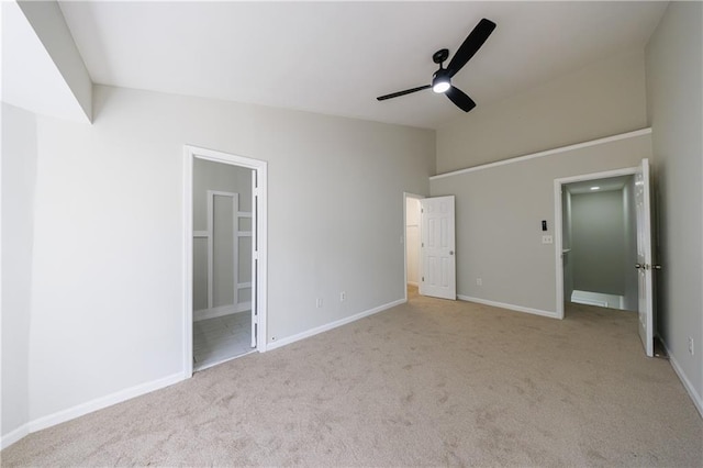 unfurnished bedroom featuring ensuite bathroom, ceiling fan, carpet flooring, and baseboards