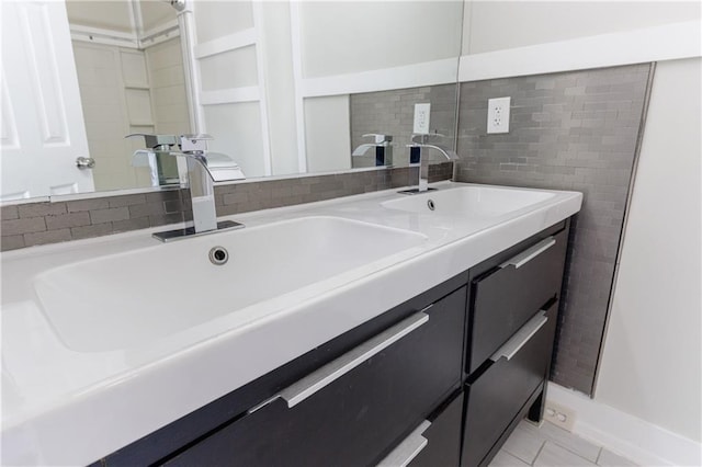 full bathroom featuring double vanity, tile patterned flooring, and a sink