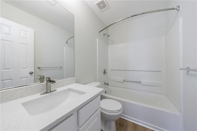 bathroom with bathtub / shower combination, visible vents, toilet, vanity, and wood finished floors