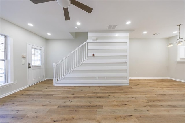 foyer entrance featuring baseboards, visible vents, stairs, light wood-type flooring, and recessed lighting