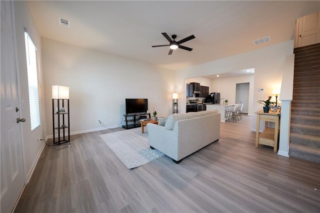 458 Bishop Ln, Woodstock, GA 30188 - living area with wood finished floors, ceiling fan, stairs, and plenty of natural light
