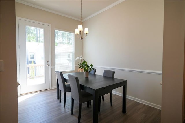458 Bishop Ln, Woodstock, GA 30188 - dining area featuring a chandelier, dark wood-style flooring, crown molding, and baseboards