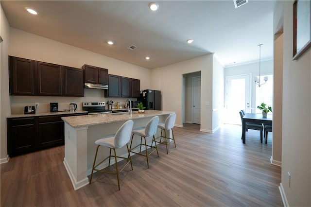 458 Bishop Ln, Woodstock, GA 30188 - kitchen with stainless steel range with electric cooktop, under cabinet range hood, a sink, baseboards, and recessed lighting