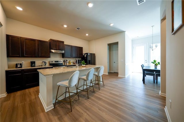 458 Bishop Ln, Woodstock, GA 30188 - kitchen featuring stainless steel range with electric cooktop, black fridge, a sink, a chandelier, and baseboards