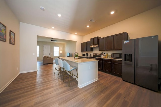 458 Bishop Ln, Woodstock, GA 30188 - kitchen featuring stainless steel appliances, a sink, dark wood-style flooring, open floor plan, and a kitchen island with sink