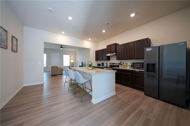 458 Bishop Ln, Woodstock, GA 30188 - kitchen featuring appliances with stainless steel finishes, a sink, open floor plan, wood finished floors, and recessed lighting