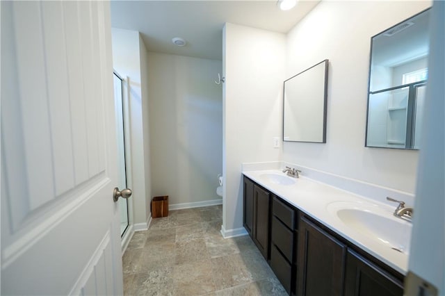 458 Bishop Ln, Woodstock, GA 30188 - full bath featuring double vanity, toilet, a stall shower, stone finish flooring, and baseboards