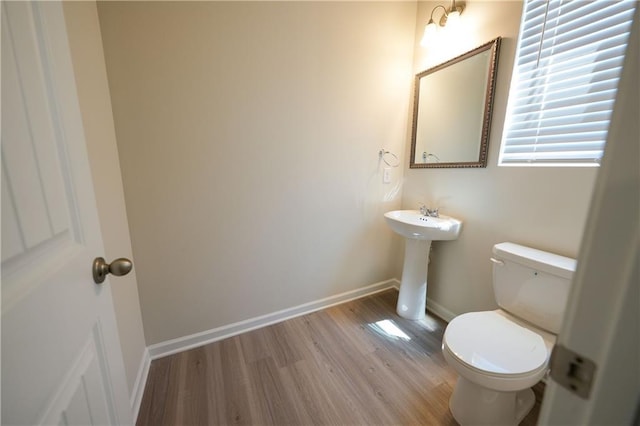 458 Bishop Ln, Woodstock, GA 30188 - bathroom featuring toilet, wood finished floors, and baseboards