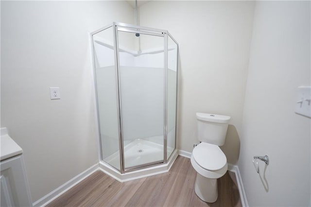 458 Bishop Ln, Woodstock, GA 30188 - full bath featuring wood finished floors, toilet, a stall shower, and baseboards