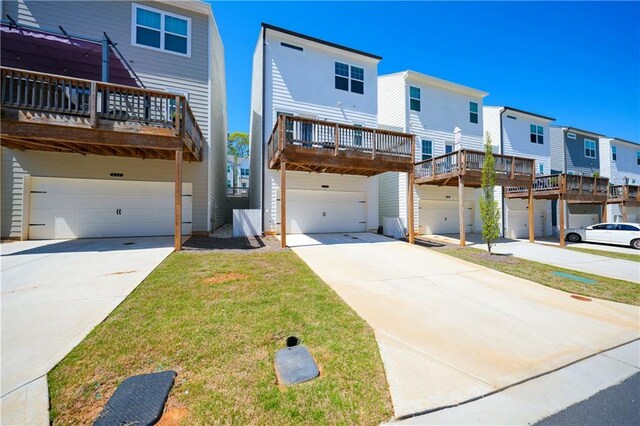 458 Bishop Ln, Woodstock, GA 30188 - view of front facade with an attached garage, concrete driveway, a residential view, and a carport