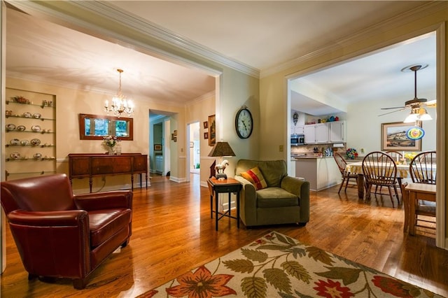 3833 Savannah Sq E, Atlanta, GA 30340 - living room featuring a chandelier, a ceiling fan, wood finished floors, and crown molding