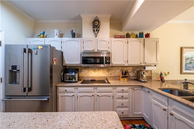 3833 Savannah Sq E, Atlanta, GA 30340 - kitchen with appliances with stainless steel finishes, a sink, crown molding, backsplash, and dark wood finished floors