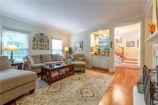 3833 Savannah Sq E, Atlanta, GA 30340 - living area with crown molding, stairs, light wood-style floors, and a chandelier
