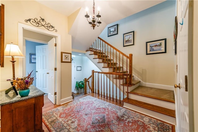 3833 Savannah Sq E, Atlanta, GA 30340 - staircase with a chandelier, wood finished floors, and baseboards