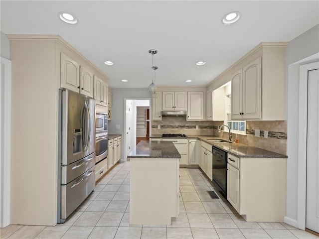 kitchen featuring decorative backsplash, a center island, stainless steel appliances, and sink