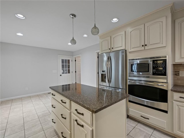 kitchen with pendant lighting, dark stone counters, appliances with stainless steel finishes, tasteful backsplash, and light tile patterned flooring