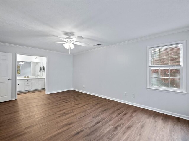 unfurnished bedroom with ensuite bath, ceiling fan, hardwood / wood-style floors, and crown molding