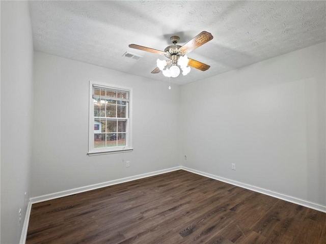 unfurnished room featuring a textured ceiling, ceiling fan, and dark wood-type flooring