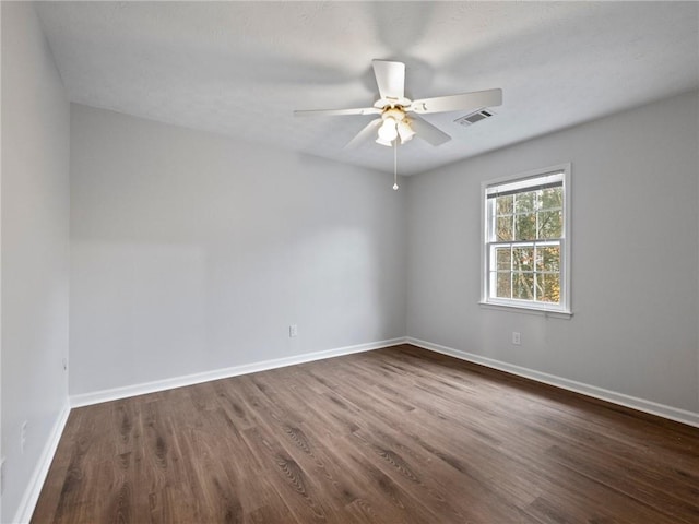 unfurnished room with ceiling fan and dark wood-type flooring