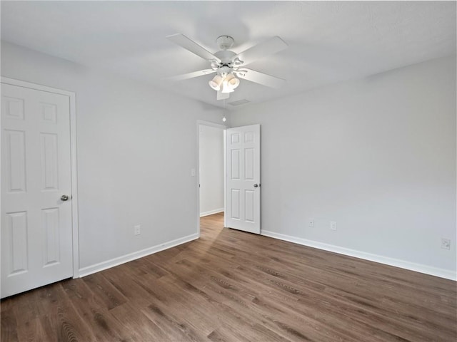 unfurnished room featuring dark hardwood / wood-style floors and ceiling fan