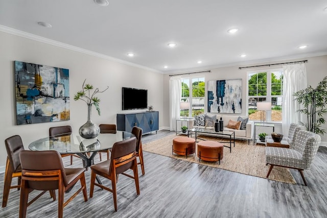 dining space with hardwood / wood-style flooring and crown molding