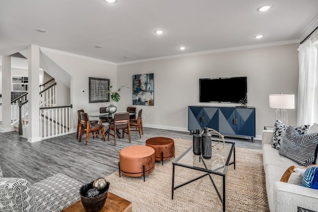 living room with hardwood / wood-style floors and crown molding