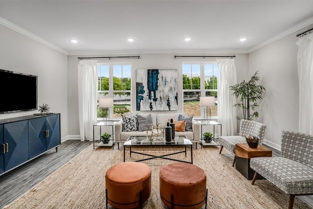 living area featuring hardwood / wood-style flooring, plenty of natural light, and ornamental molding