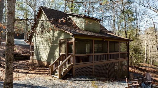 back of house featuring a sunroom