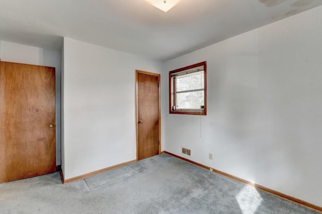 unfurnished bedroom with visible vents, baseboards, and carpet flooring