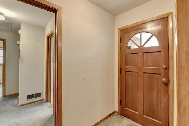 entrance foyer with baseboards, visible vents, and light carpet