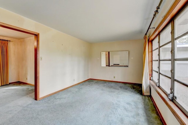 empty room with baseboards and carpet floors