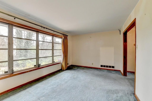 unfurnished room featuring baseboards, carpet floors, and visible vents