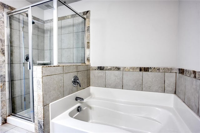 bathroom with tile patterned floors and independent shower and bath