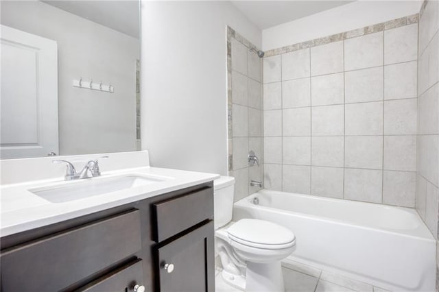 full bathroom featuring toilet, vanity, tile patterned floors, and tiled shower / bath