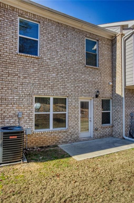 back of property featuring a yard, a patio, and central AC unit