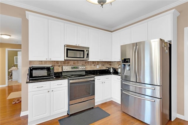 kitchen featuring appliances with stainless steel finishes, backsplash, white cabinets, crown molding, and light wood-type flooring