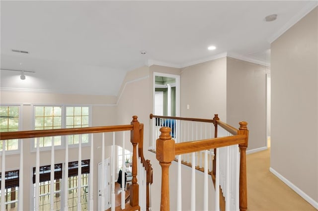 corridor featuring light carpet, track lighting, ornamental molding, and lofted ceiling