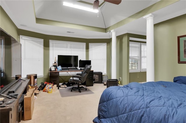 bedroom with ornate columns, carpet flooring, ceiling fan, a raised ceiling, and crown molding