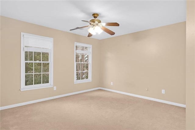 carpeted spare room featuring ceiling fan