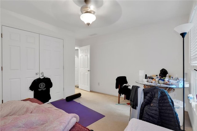 bedroom featuring light colored carpet and a closet