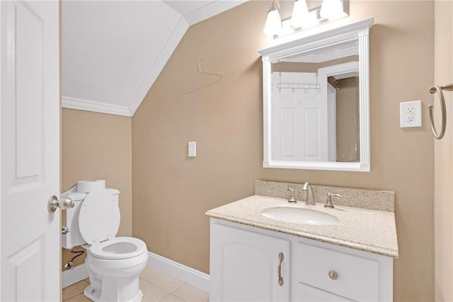 bathroom with vaulted ceiling, tile patterned flooring, ornamental molding, vanity, and toilet