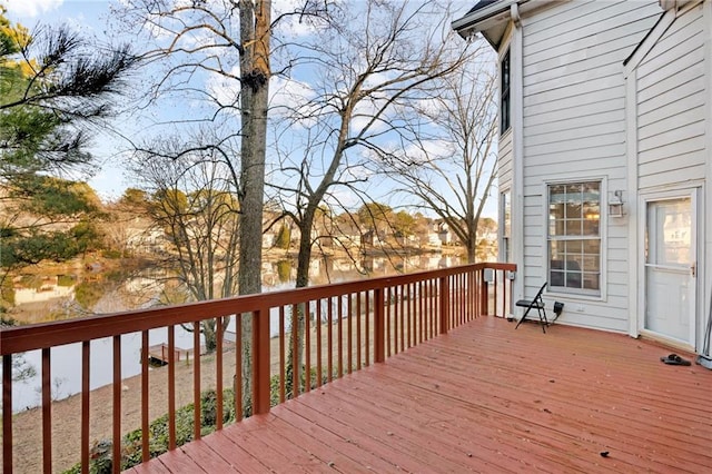 wooden terrace featuring a water view