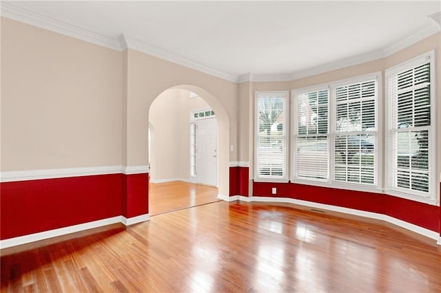 spare room with wood-type flooring and crown molding