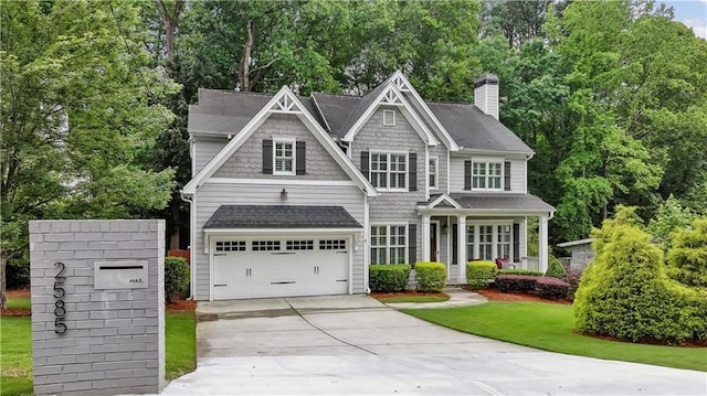 2585 Drew Valley Rd NE, Brookhaven, GA 30319 - view of front of home featuring concrete driveway, covered porch, a chimney, and a shingled roof