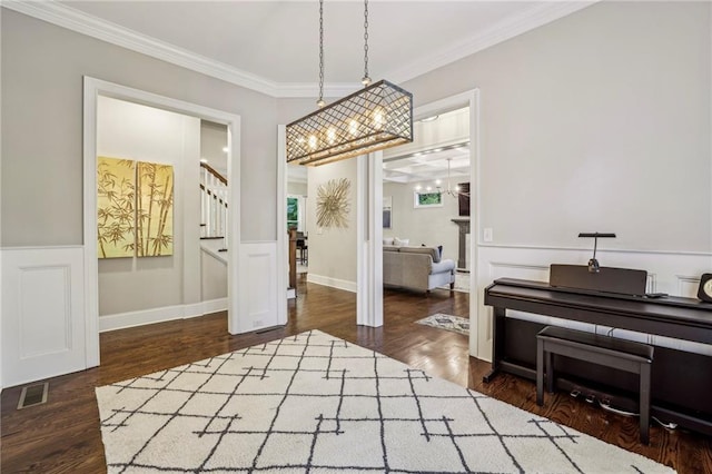 2585 Drew Valley Rd NE, Brookhaven, GA 30319 - dining area with crown molding, stairs, wood finished floors, a chandelier, and wainscoting