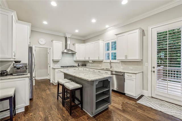 2585 Drew Valley Rd NE, Brookhaven, GA 30319 - kitchen with appliances with stainless steel finishes, wall chimney range hood, a sink, white cabinets, and crown molding